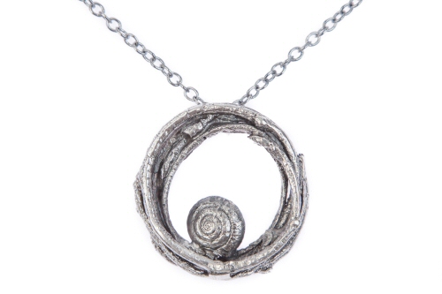 Circle of twigs with snail pendant.